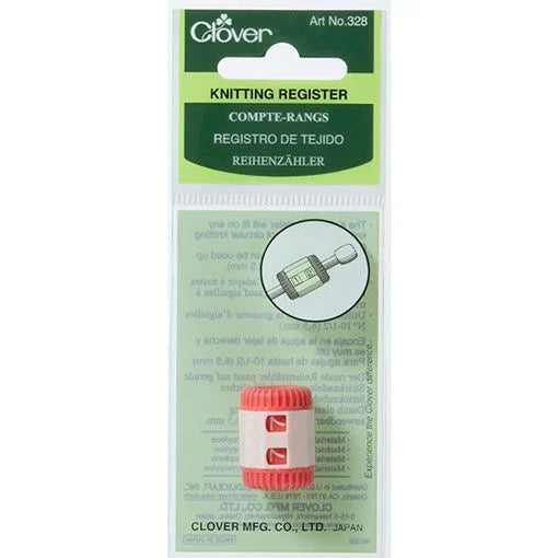 A Clover knitting register with a red and white striped body, shown in its original green and white retail packaging.