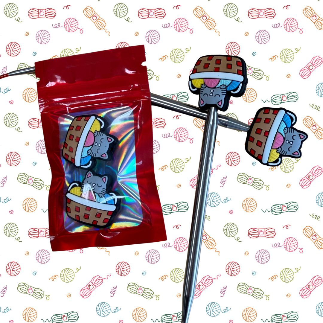Point Protectors: Colorful cat-themed chopsticks with a red packaging bag on a patterned background