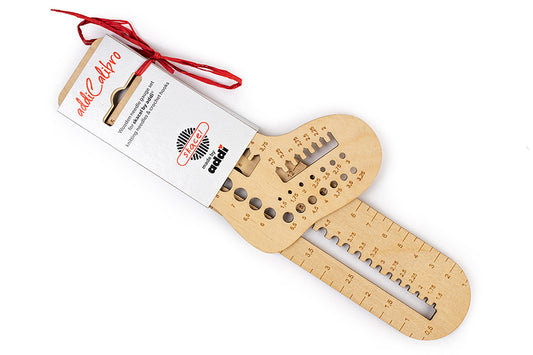 Wooden tool with measurement scale and packaging on a white background