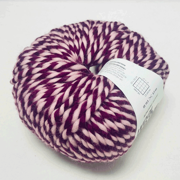 Alpachino Merino, Ball of purple and pink yarn with a label on a white background