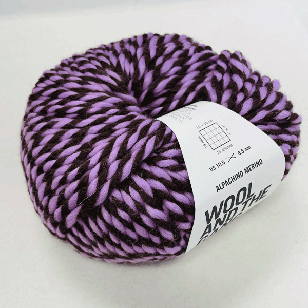 Alpachino Merino, Ball of purple and brown yarn with a label on a white background