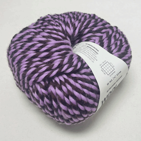 Alpachino Merino, Purple and black skein of yarn with a label on a white background