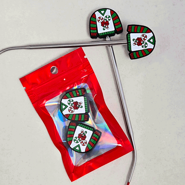 Point Protectors: Decorative Christmas-themed earrings in a red packaging on a light gray background